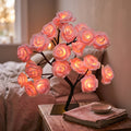 Enchanted Rose LED Table Lamp glowing on a nightstand