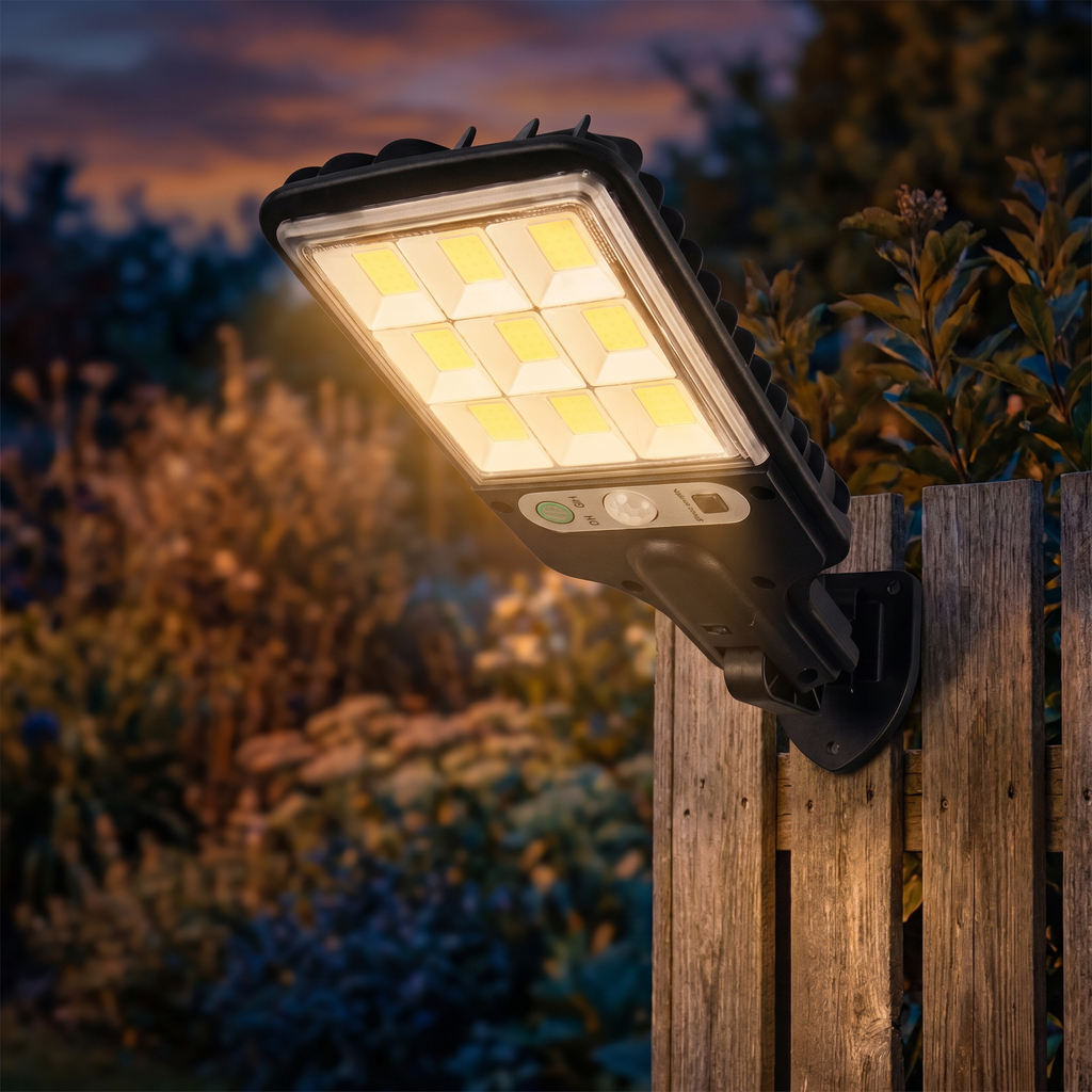 Solar LED wall light glowing on a garden fence at dusk