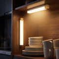 Motion-sensor LED light glowing in a kitchen cabinet